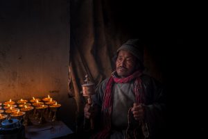 Old Man doing prayer in monastery, Ladakh